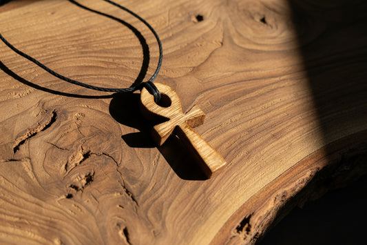 Wooden Ankh pendant on a wooden surface NZ